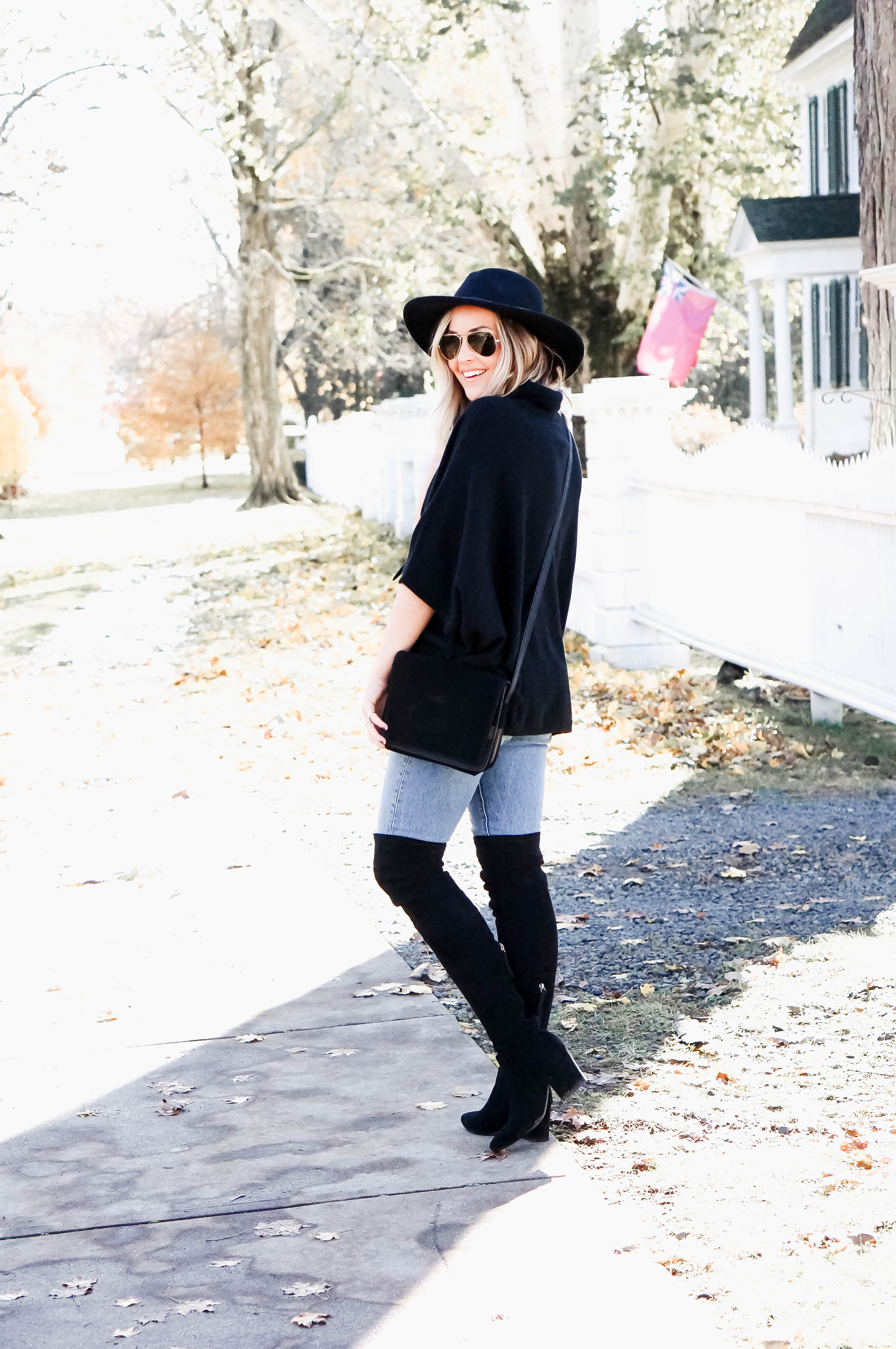 black turtleneck poncho over the knee boots